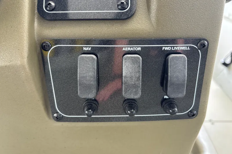 Slide: The Image of Control panel of 2026 Tracker Grizzly 2072 CC with switches for navigation, aerator, and livewell. - 23