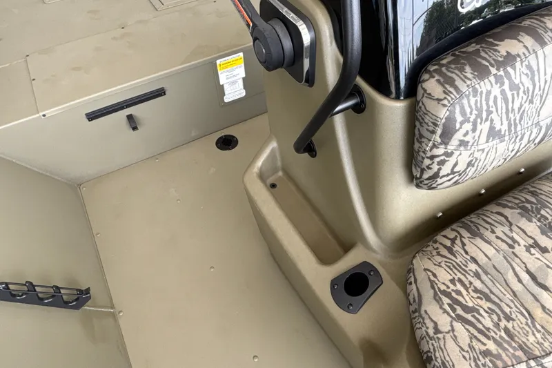 Slide: The Image of Interior of 2026 Tracker Grizzly 2072 CC boat with camo seating and control panel. - 25
