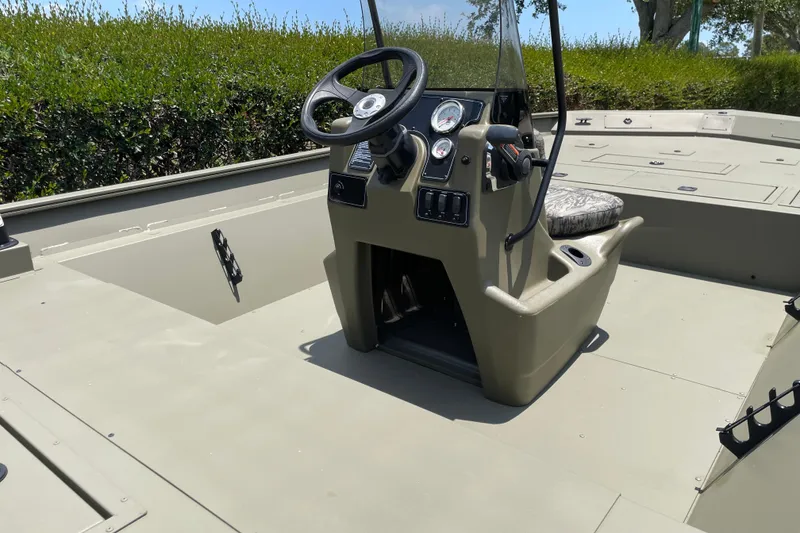 Slide: The Image of 2026 Tracker Grizzly 2072 CC boat interior with steering console and seating. - 47