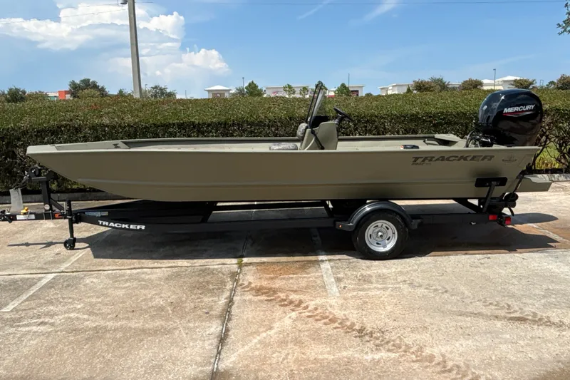 The Image of 2026 Tracker Grizzly 2072 CC boat on trailer, parked outdoors under clear sky. - 0