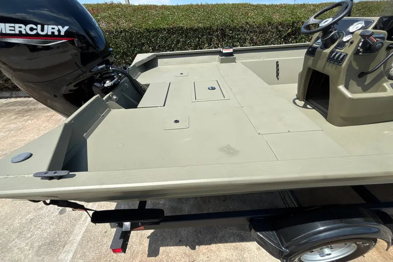 Slide: The Image of 2026 Tracker Grizzly 2072 CC boat with Mercury engine, featuring spacious deck and control console. - 16