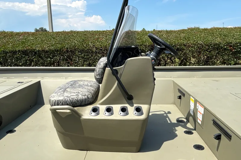 Slide: The Image of 2026 Tracker Grizzly 2072 CC boat console with steering wheel and cushioned seat. - 19