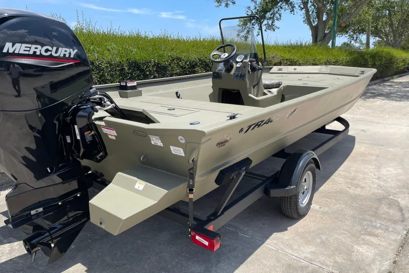Slide: The Image of 2026 Tracker Grizzly 2072 CC boat with Mercury engine on trailer, parked outdoors. - 42