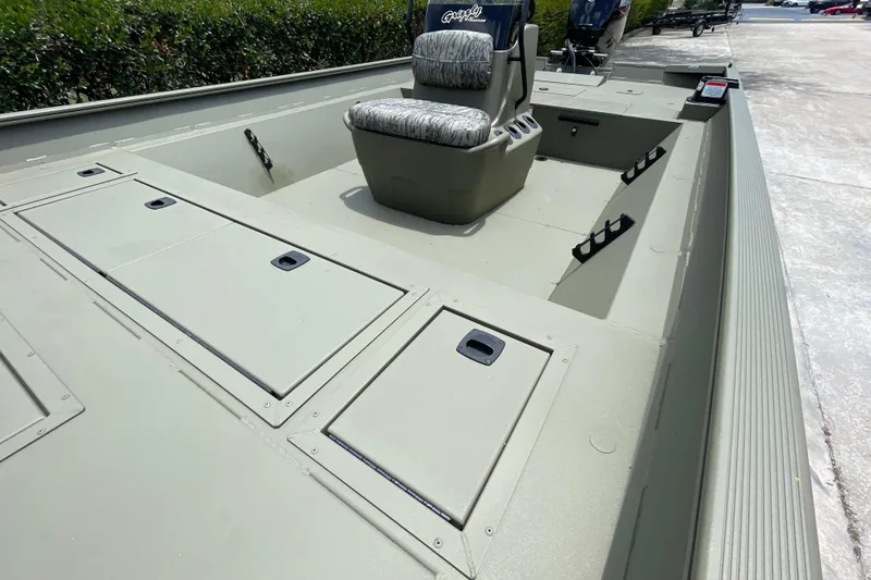 Slide: The Image of 2026 Tracker Grizzly 2072 CC boat interior with storage compartments and seating. - 50