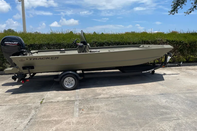 Slide: The Image of 2026 Tracker Grizzly 2072 CC boat on trailer, parked outdoors under clear sky. - 38