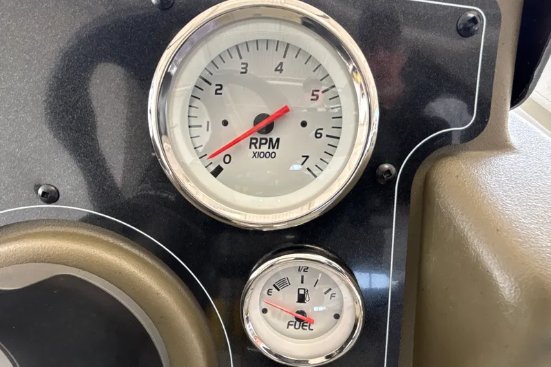 Slide: The Image of RPM and fuel gauges on 2026 Tracker Grizzly 2072 CC dashboard. - 22