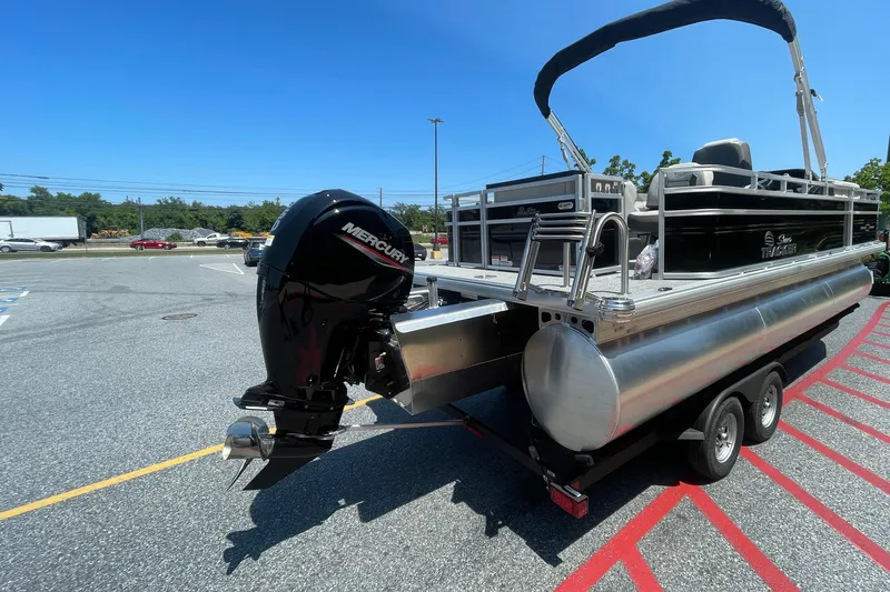 Slide: The Image of 2026 Sun Tracker Fishin' Barge 22 XP3 pontoon boat with Mercury outboard motor. - 1