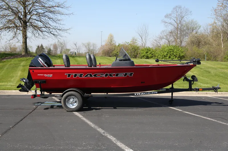 The Image of 2026 Tracker Pro Guide V-16 SC boat on trailer, parked outdoors. - 0