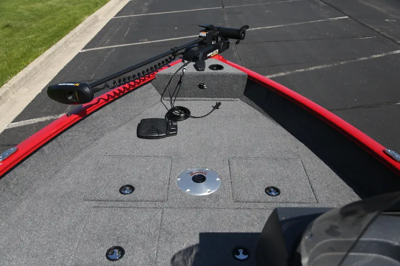 Slide: The Image of 2026 Tracker Pro Guide V-16 SC boat deck with trolling motor, red trim, and storage compartments. - 2