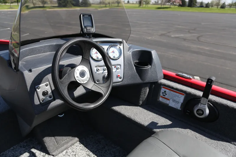 Slide: The Image of 2026 Tracker Pro Guide V-16 SC boat dashboard with steering wheel and controls. - 3