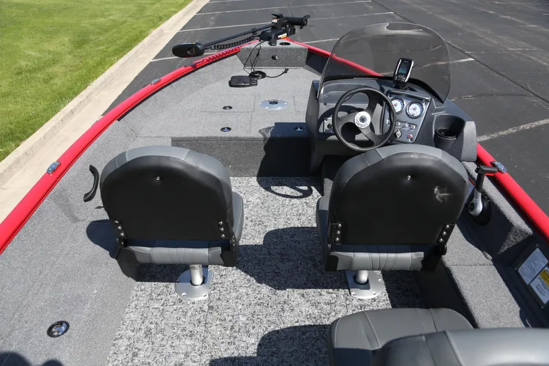 Slide: The Image of 2026 Tracker Pro Guide V-16 SC boat interior with steering console and seating. - 5
