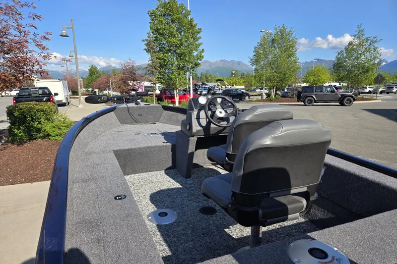Slide: The Image of 2026 Tracker Super Guide V-16 SC boat with dual seats, parked outdoors on a sunny day. - 6