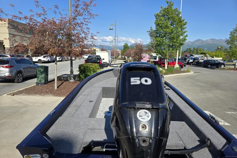 Slide: The Image of 2026 Tracker Super Guide V-16 SC boat with Mercury 50 engine in parking lot. - 4