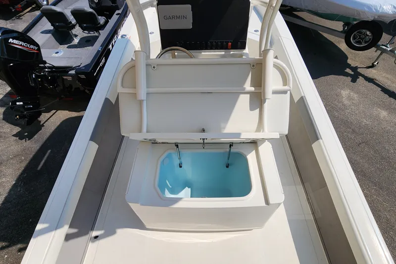 Slide: The Image of 2026 Mako 24 APEX boat with open storage compartment and Garmin equipment. - 6