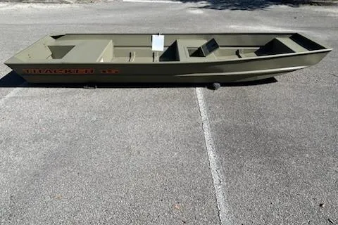 The Image of 2026 Tracker Grizzly 15 Jon boat on pavement, showcasing its sleek design and durable build. - 0