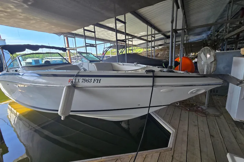 The Image of 2001 Cobalt 292 boat docked in a covered marina, side view. - 1