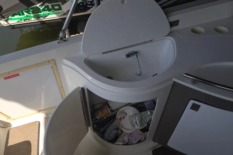 Slide: The Image of Interior of a 2001 Cobalt 292 boat featuring a sink and storage area. - 13
