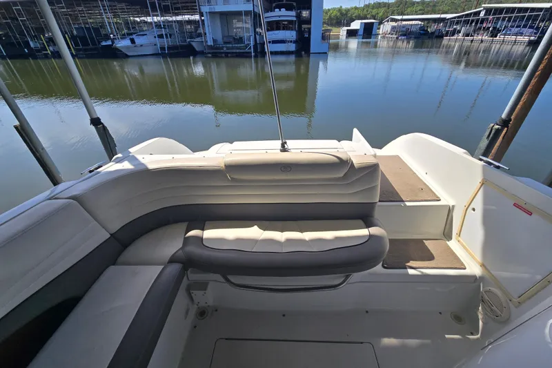 Slide: The Image of 2001 Cobalt 292 boat interior with cushioned seating, docked at a marina. - 14