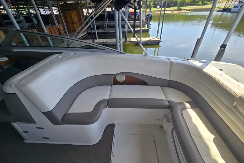 Slide: The Image of Interior seating of a 2001 Cobalt 292 boat docked by the water. - 15