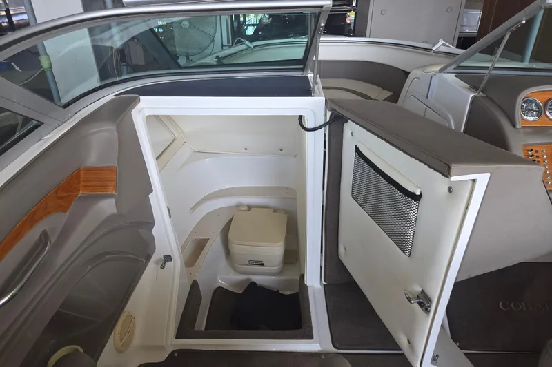 Slide: The Image of Interior of a 2001 Cobalt 292 boat featuring a compact marine toilet. - 18