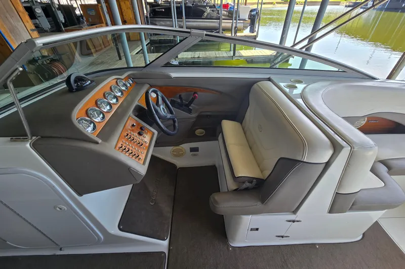 Slide: The Image of Interior of a 2001 Cobalt 292 boat, featuring a sleek dashboard and comfortable seating. - 19