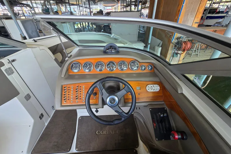 Slide: The Image of Cockpit of a 2001 Cobalt 292 boat with wooden dashboard and steering wheel. - 20