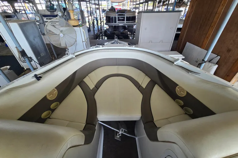 Slide: The Image of Interior view of a 2001 Cobalt 292 boat with beige seating in a marina. - 21