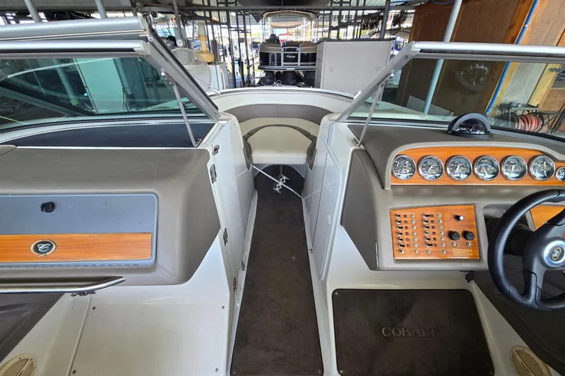 Slide: The Image of Interior of a 2001 Cobalt 292 boat, featuring a sleek dashboard and steering wheel. - 22