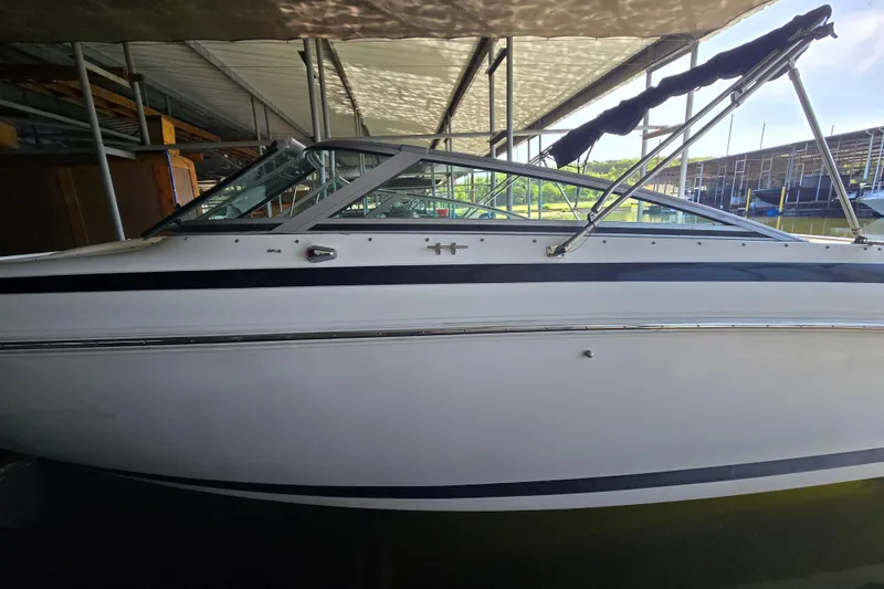 Slide: The Image of 2001 Cobalt 292 boat docked under a covered marina. - 4
