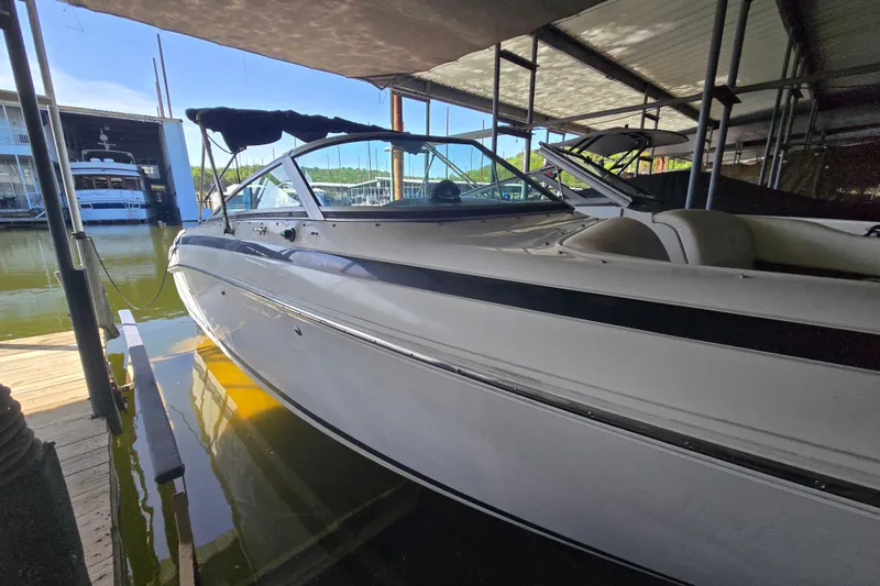 Slide: The Image of 2001 Cobalt 292 boat docked in a marina under a covered shelter. - 6