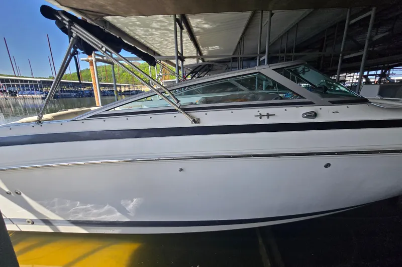 Slide: The Image of 2001 Cobalt 292 boat docked under a covered marina. - 7