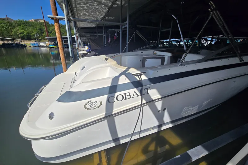 Slide: The Image of 2001 Cobalt 292 boat docked in a marina, partially shaded, with visible branding. - 8