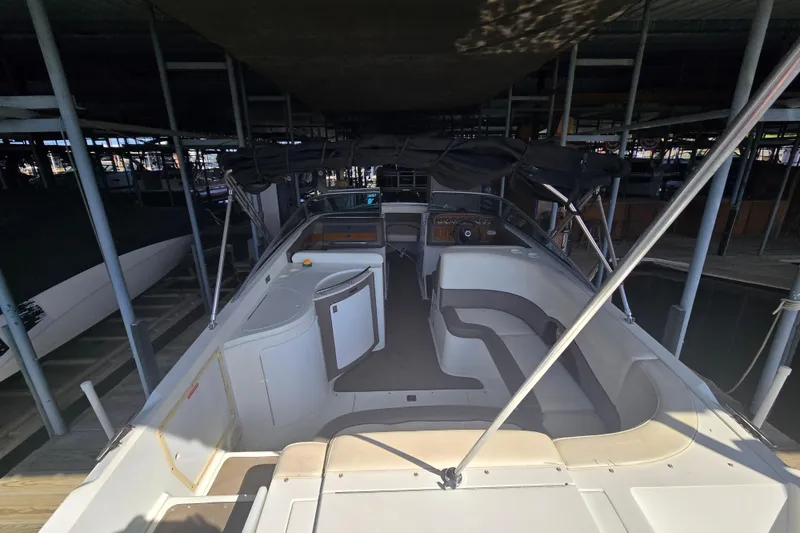 Slide: The Image of 2001 Cobalt 292 boat interior with seating and dashboard, docked in a covered marina. - 9