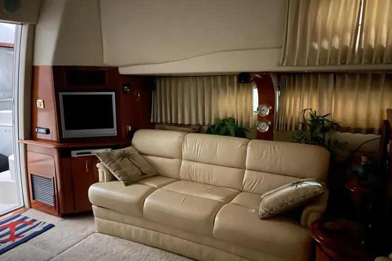 Slide: The Image of Luxurious interior of 2004 Carver 420 Mariner yacht with beige sofa and entertainment center. - 11