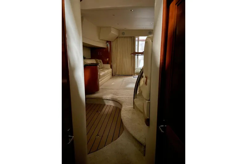 Slide: The Image of Interior of 2004 Carver 420 Mariner yacht, featuring elegant seating and wooden accents. - 12