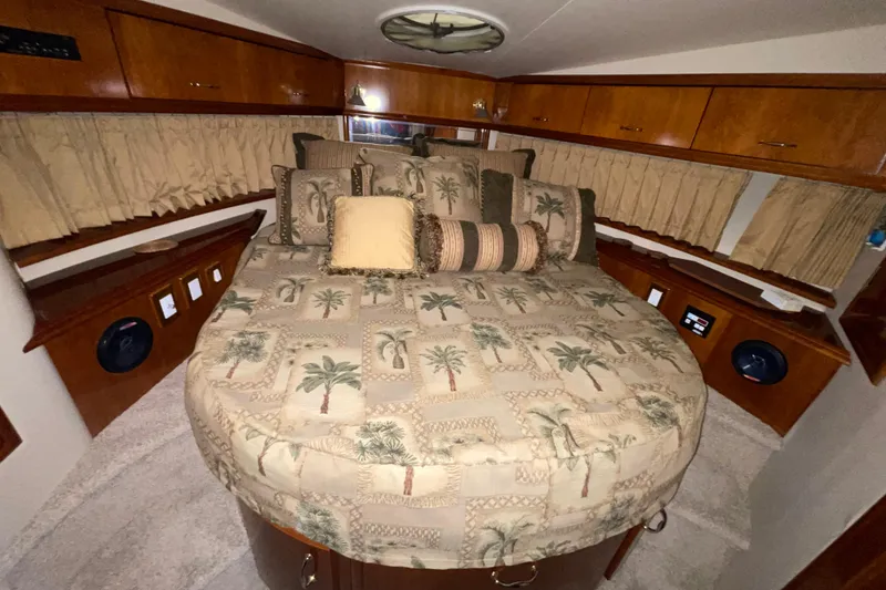 Slide: The Image of Luxurious cabin interior of 2004 Carver 420 Mariner with plush bedding and wood accents. - 13