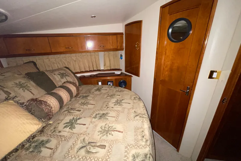 Slide: The Image of Luxurious cabin interior of 2004 Carver 420 Mariner with wood finishes and cozy bedding. - 15