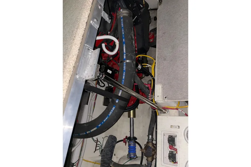 Slide: The Image of Engine compartment of 2004 Carver 420 Mariner with hoses and cables. - 18