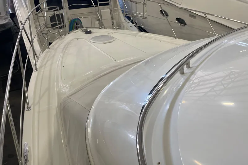 Slide: The Image of 2004 Carver 420 Mariner yacht deck with sleek design and stainless steel railings. - 23