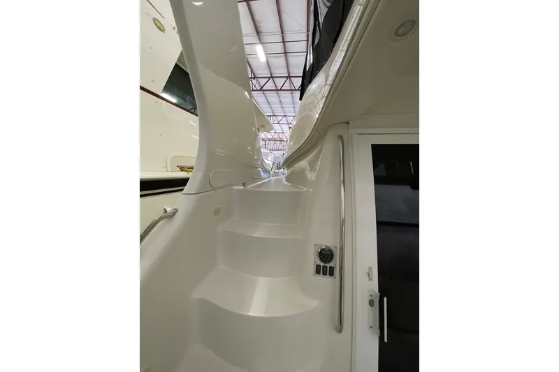 Slide: The Image of Staircase on 2004 Carver 420 Mariner yacht, showcasing sleek white design and modern features. - 26