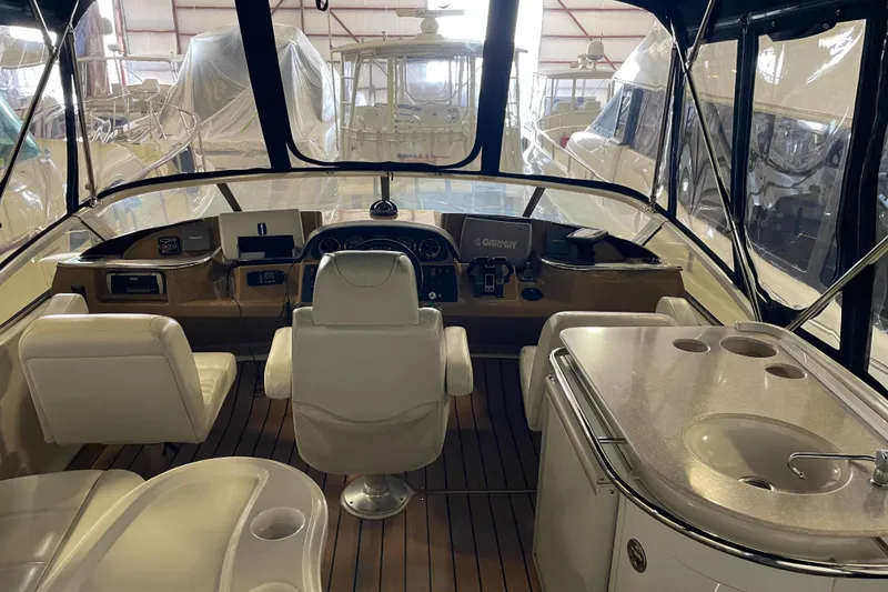 Slide: The Image of Interior view of 2004 Carver 420 Mariner yacht cockpit with helm and seating area. - 29