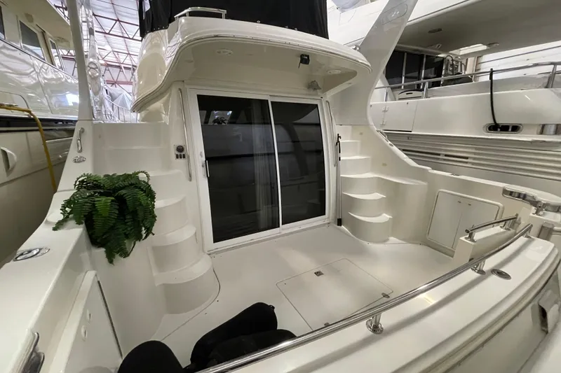 Slide: The Image of 2004 Carver 420 Mariner yacht interior with stairs and sliding glass doors. - 3