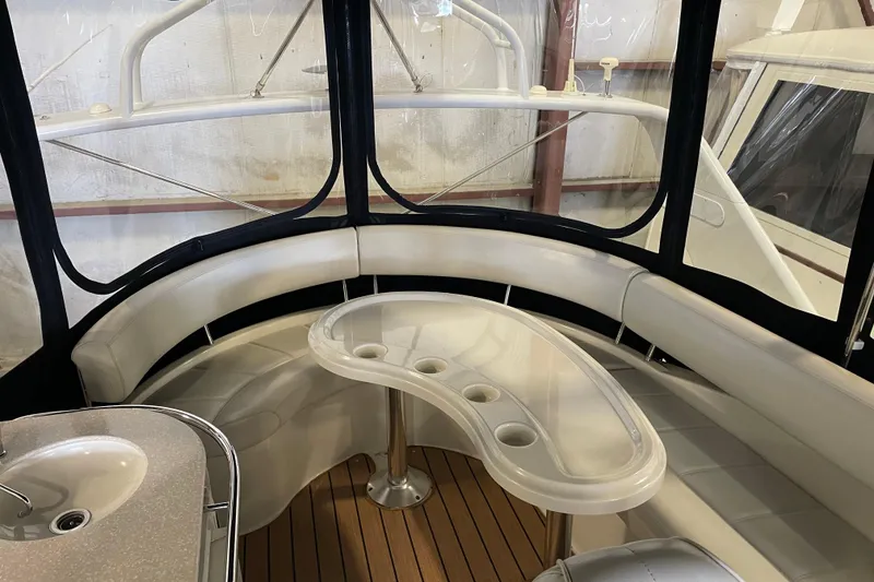 Slide: The Image of Interior of 2004 Carver 420 Mariner yacht with curved seating and table. - 30