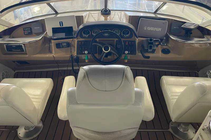 Slide: The Image of Cockpit of 2004 Carver 420 Mariner with steering wheel and navigation equipment. - 34