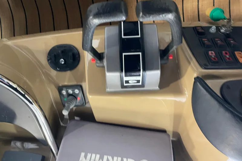 Slide: The Image of Control panel of a 2004 Carver 420 Mariner boat with throttle levers and switches. - 36