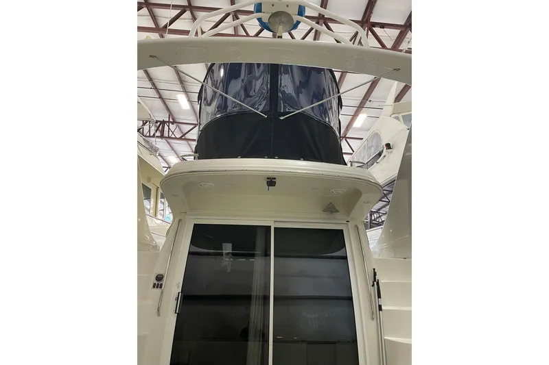Slide: The Image of 2004 Carver 420 Mariner yacht in indoor storage, rear view with enclosed flybridge. - 5