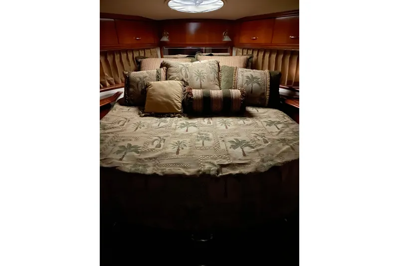 Slide: The Image of Luxurious bedroom interior of 2004 Carver 420 Mariner yacht with elegant bedding and cushions. - 7