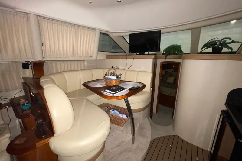 Slide: The Image of Interior of 2004 Carver 420 Mariner yacht with cozy seating and modern amenities. - 9