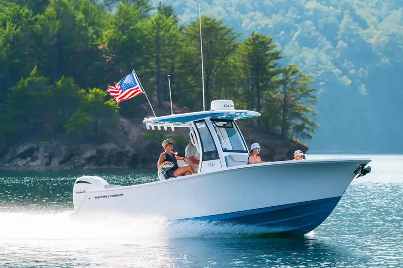 The Image of Manufacturer Provided Image: 2026 Sportsman Heritage 231 Center Console boat cruising on a scenic lake. - 0