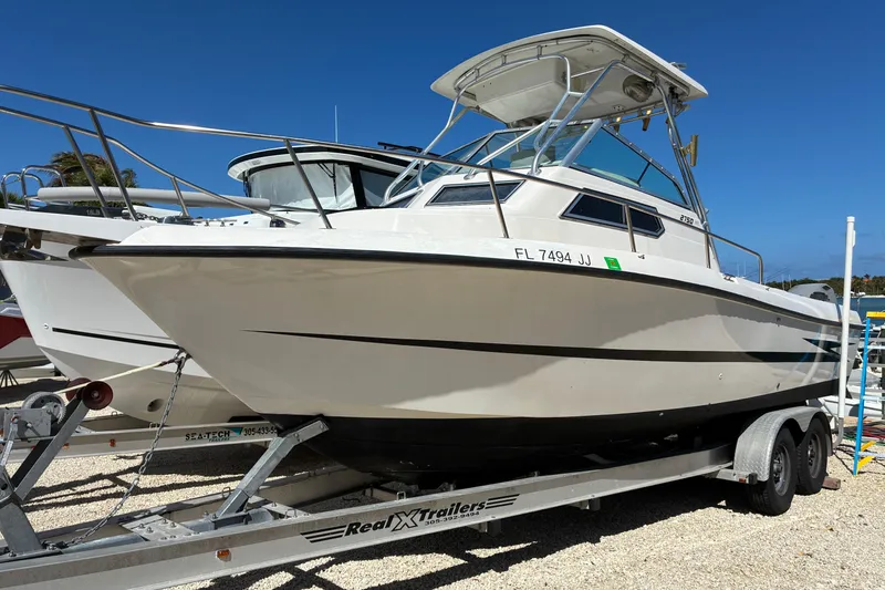 The Image of 1997 Hydra-Sports 2750 WA boat on trailer, parked outdoors under clear blue sky. - 1